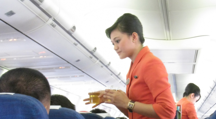 Flight attendant serving refreshment