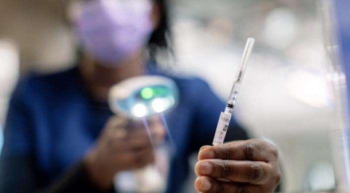 Healthcare worker prepares a vaccine dose