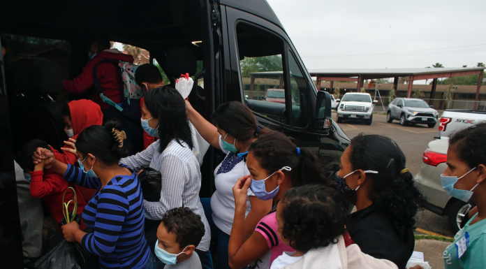 Migrants board a van at Our Lady of Guadalupe Catholic Church in Mission, Texas,Migrants board a van at Our Lady of Guadalupe Catholic Church in Mission, Texas,Migrants board a van in Mission, Texas.