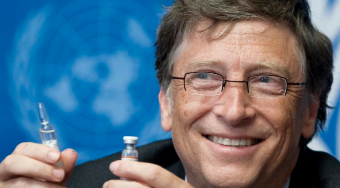 Bill Gates, Co-Chair the Bill & Melinda Gates Foundation shows a vaccine during the press conference.