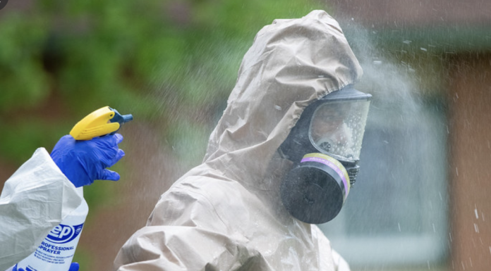 A disinfection team specialist goes through decontamination procedures