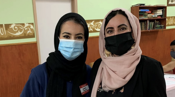 Sumaya Muhamed and her mother, Suad Abdulla, pose after Suad's second vaccine dose at the Salahadeen Center in Nashville, Tennessee. After weeks of affectionate cajoling and patient explanation, Muhamed persuaded her mother to get the shot.
