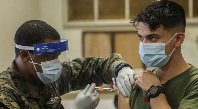 Military medical personnel at Camp Lejeune, N.C., administer coronavirus vaccines in January. | U.S. MARINE CORPS