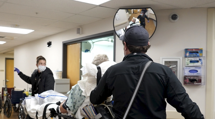 AnnieGrace Haddorff (left) and Alec Newby (right) move a patient out of Gunnison Valley Health hospital in Gunnison, Colorado, on Nov. 26. The patient, who was experiencing atrial fibrillation, had to be transported to a larger hospital with an intensive care unit 65 miles away in Montrose.