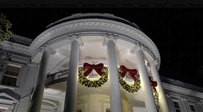 A view of the South balconies of the White House in Washington Nov. 30, 2021, lit up with holiday decorations. In addition to fewer people passing through the White House for the open houses, thousands of other people didn't get a close-up look at how Jill Biden decked out White House hallways and public rooms for the holidays because public tours of the executive mansion remain on indefinite hold due to COVID-19.