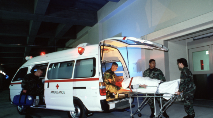 An Emergency Medical Ambulance team off loads a critical patient at the hospital emergency entrance