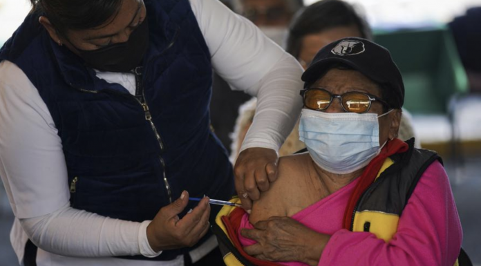A woman receives a booster against COVID-19 during a vaccination campaign for people 60 and over, in Mexico City, Tuesday, Jan. 4, 2022. (AP Photo/Fernando Llano)