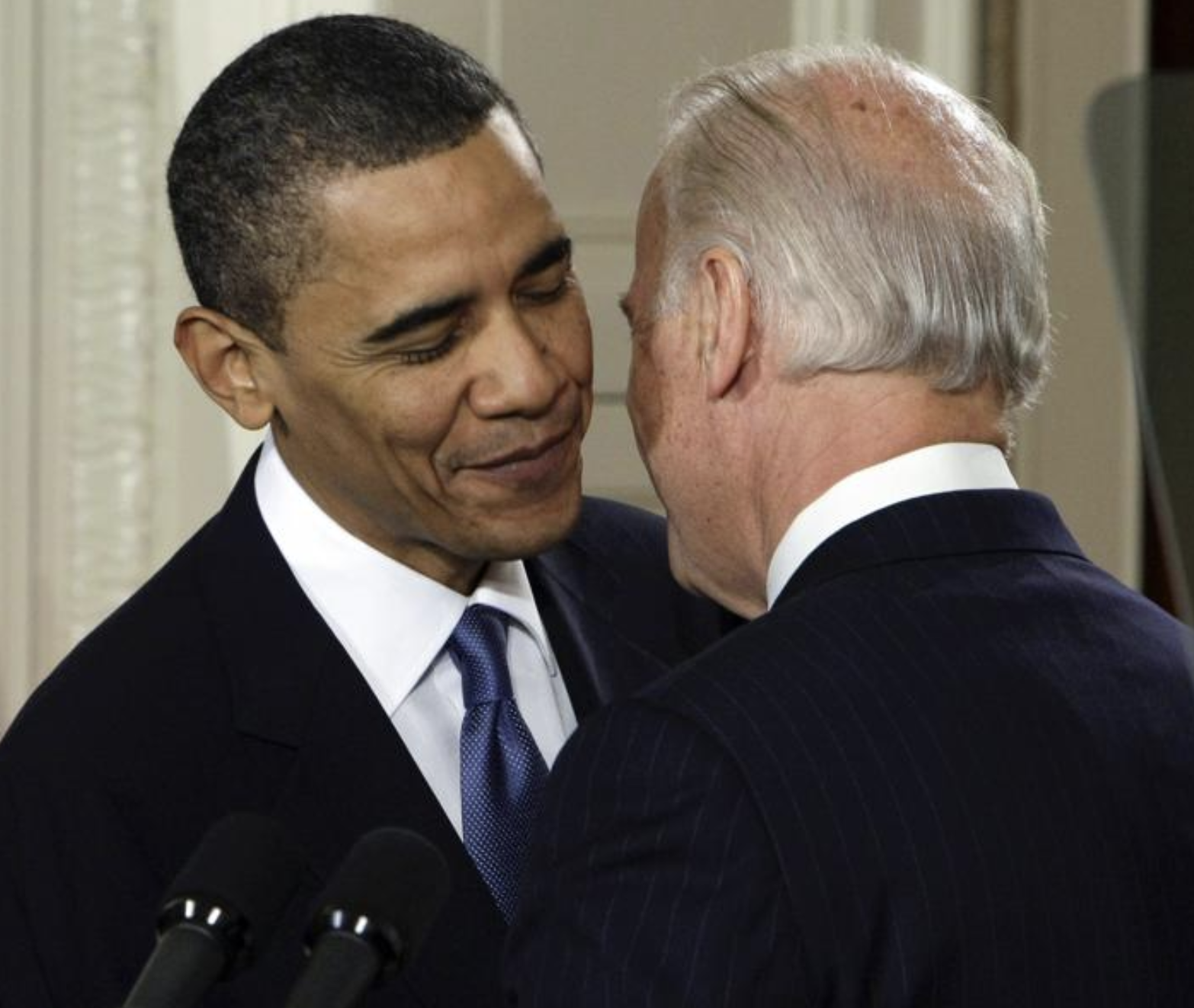 FILE - Vice President Joe Biden whispers 