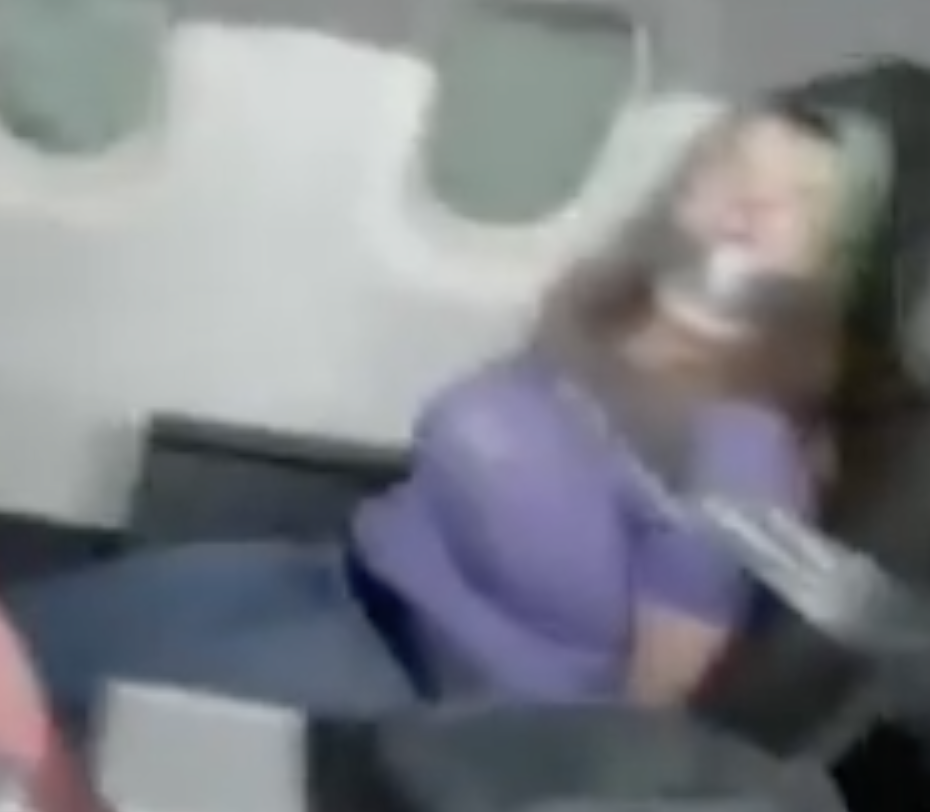 Video shows woman duct-taped to seat after trying to open airplane door