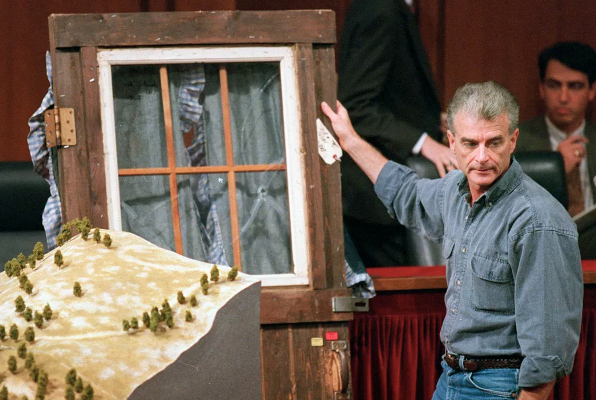 Randy Weaver holds the door of his cabin showing holes from bullets fired during the 1992 siege of his Ruby Ridge, Idaho, home during testimony before the Senate Judiciary Subcommittee on Capitol Hill in Washington, D.C., on Sept. 6, 1995.