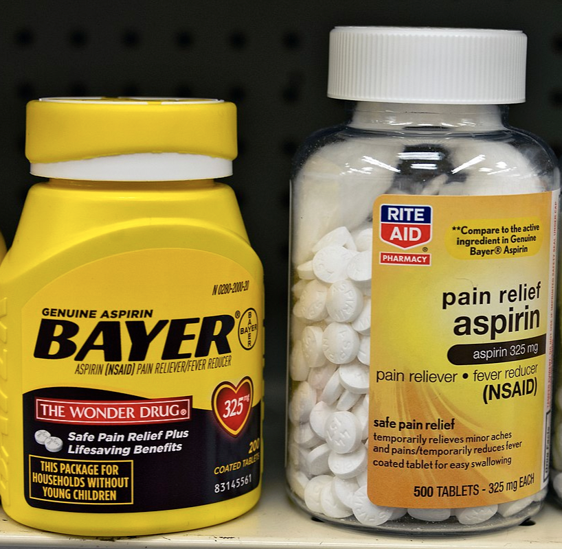Bayer and store-brand aspirin containers on US drugstore shelf