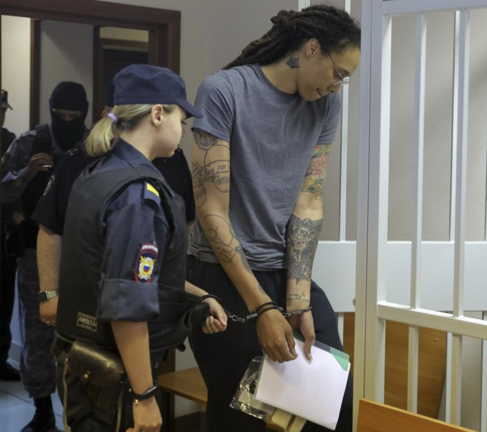 WNBA star Brittney Griner enters a cage in a courtroom prior to a hearing in Khimki just outside Moscow, Russia
