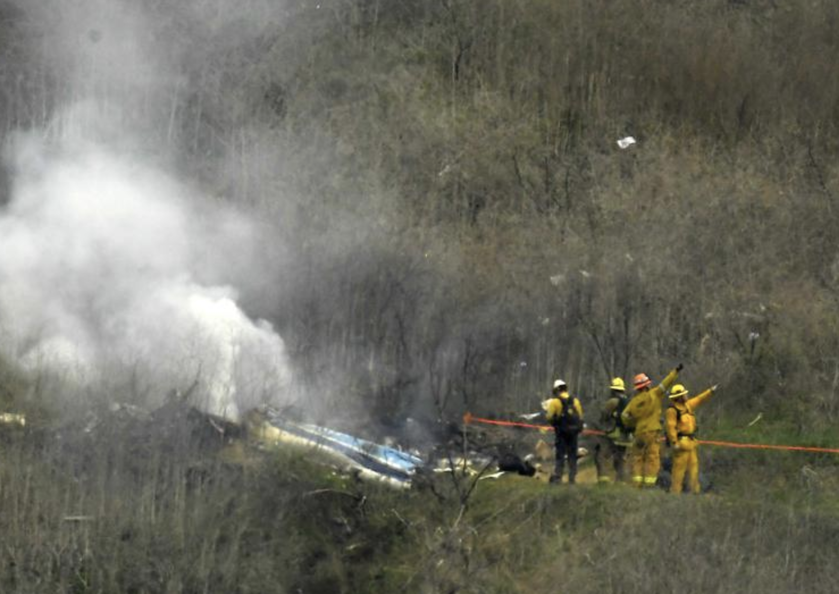 Firefighters work the scene of a helicopter crash where former NBA basketball star Kobe Bryant died