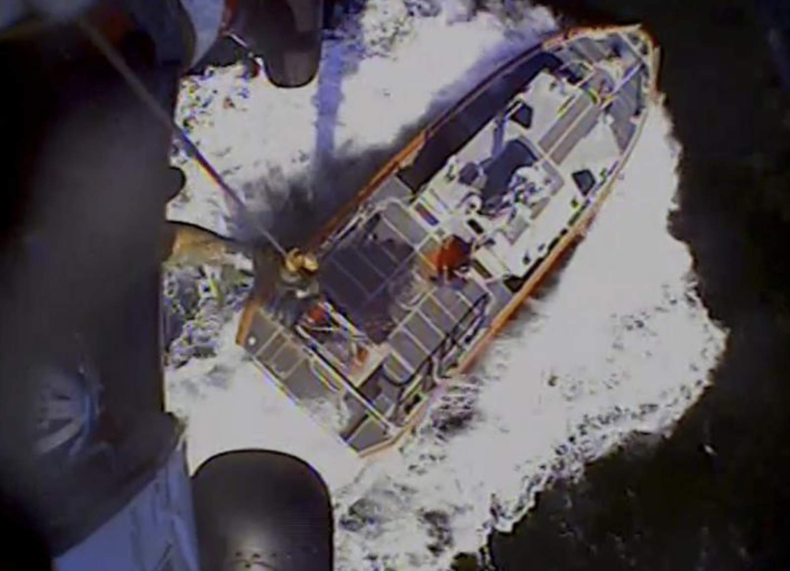 In this screenshot from video, the U.S. Coast Guard rescues boaters off the coast of Empire, La., on Sunday, Oct. 9, 2022.