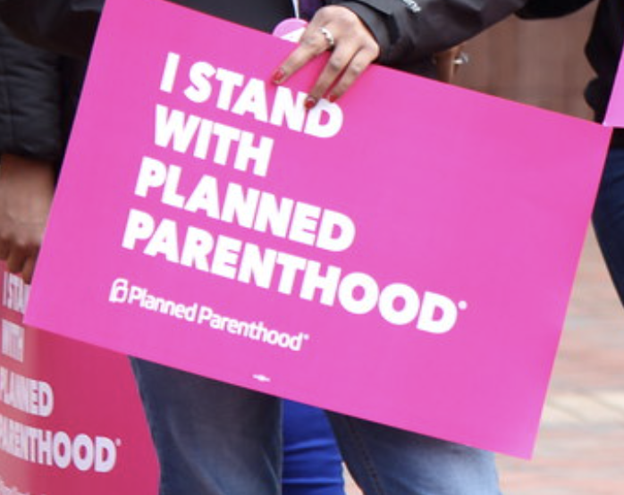 Person holding Planned Parenthood sign