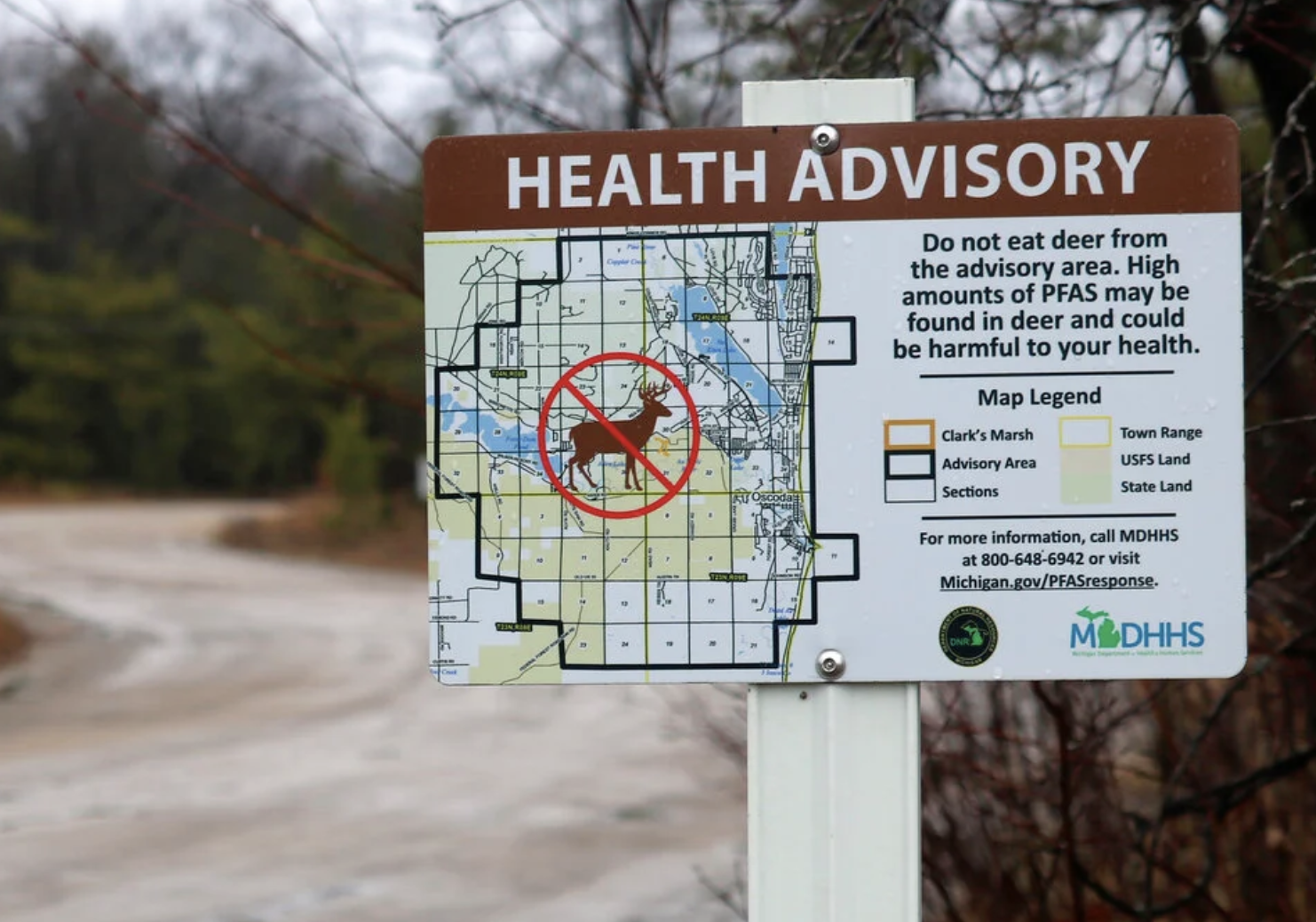 This photo provided by the National Wildlife Federation shows a sign warning hunters not to eat deer because of high amounts of toxic chemicals in their meat, in Oscoda, Mich., March 26, 2021. Drew YoungeDyke—National Wildlife Federation/AP