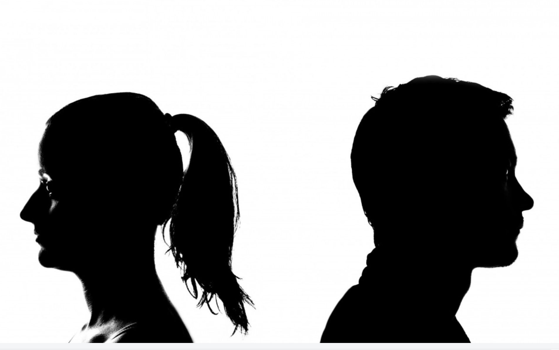 Silhouetted couple standing back to back