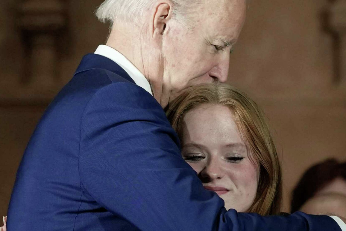 President Joe Biden hugs Sandy Hook survivor Jackie Hegarty, 17