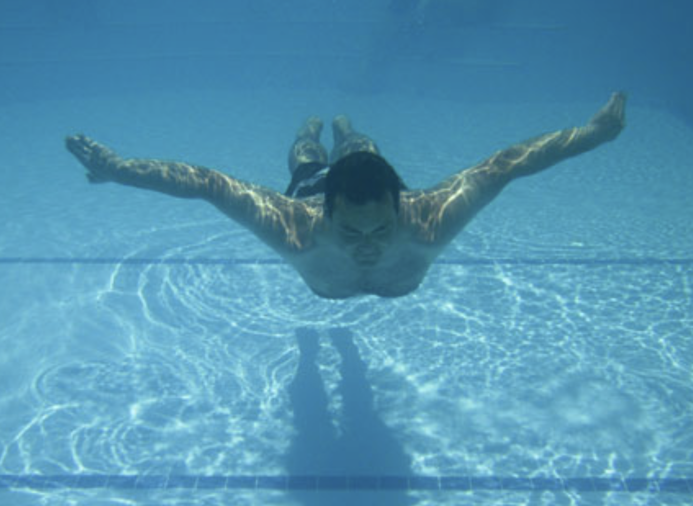 man swimming in pool