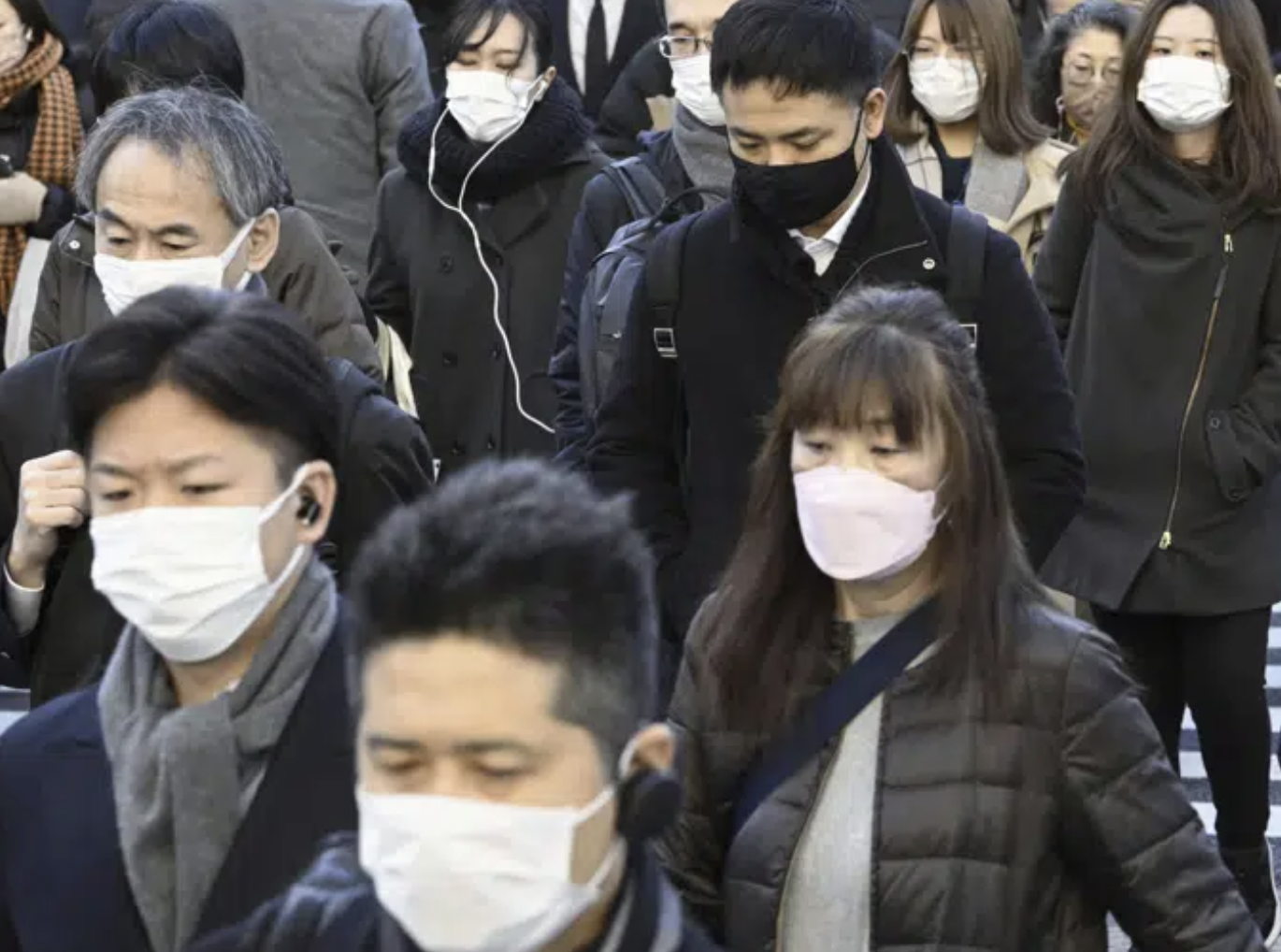 Commuters wear masks outside Tokyo Station