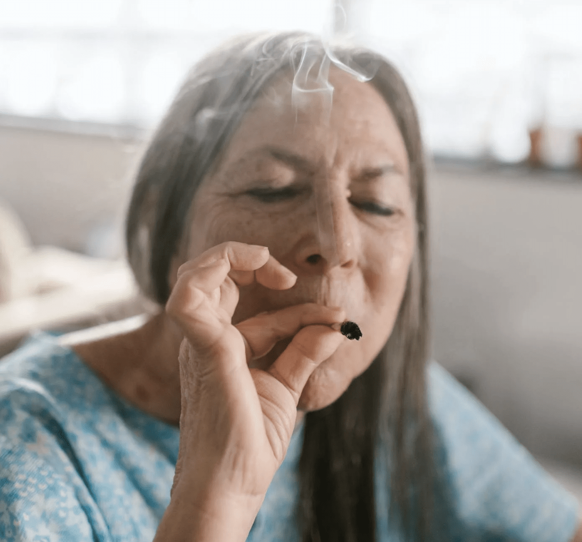 Elderly woman smoking a blunt