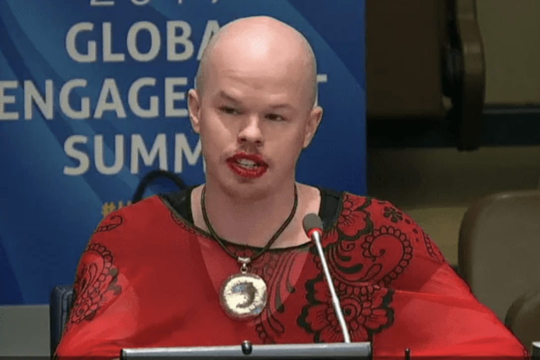 Sam Brinton speaks at the 2019 UNA-USA Global Engagement Summit while wearing a dress stolen from the luggage of a Tanzanian fashion designer.