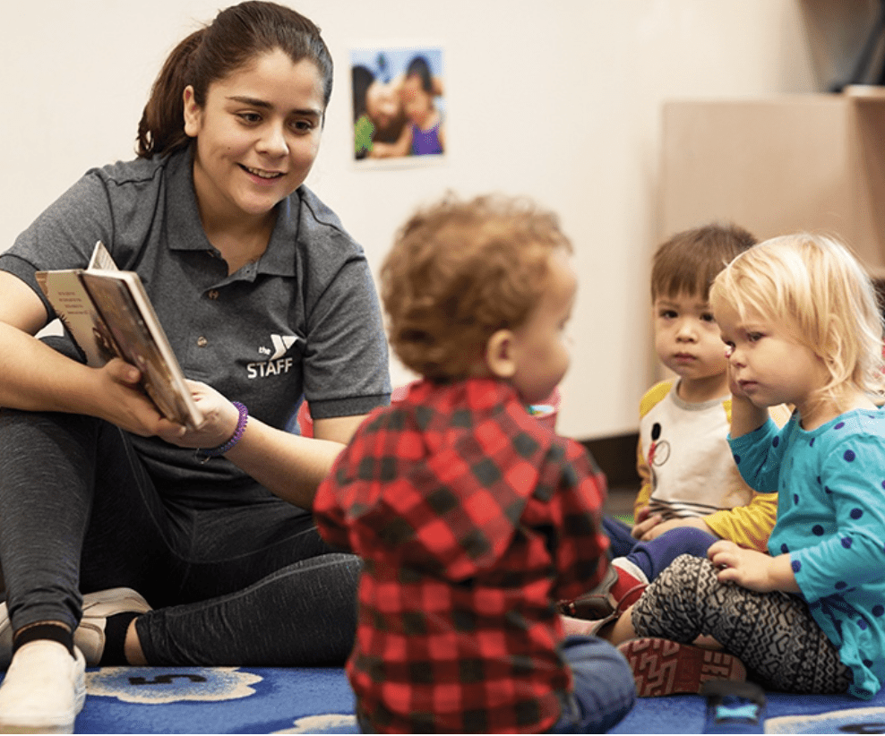 A child care provider reads to children