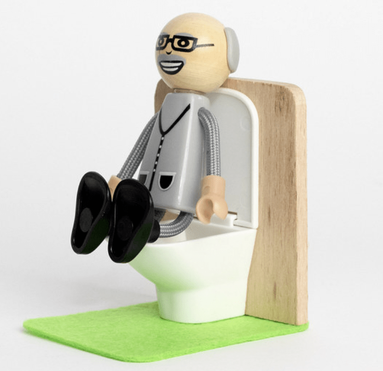 Figurine of a man sitting on a toilet