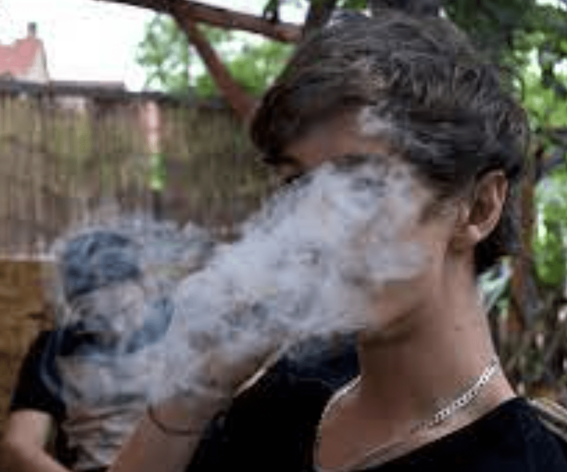 Man behind a cloud of smoke