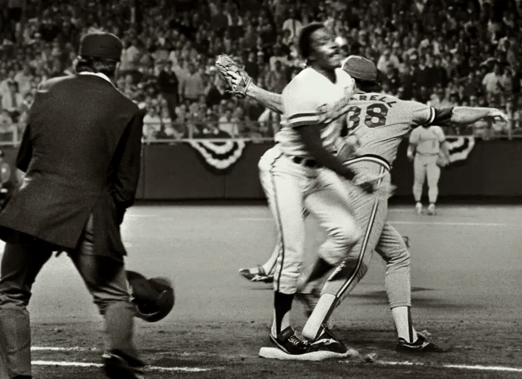 Umpire Don Denkinger, left, watches as St. Cardinals pitcher Todd Worrell, right, stretches to catch the ball as Kansas City Royals batter Jorge Orta steps on first base during the ninth inning in Game 6 of baseball's World Series in Kansas City, Mo., Oct. 26, 1985.