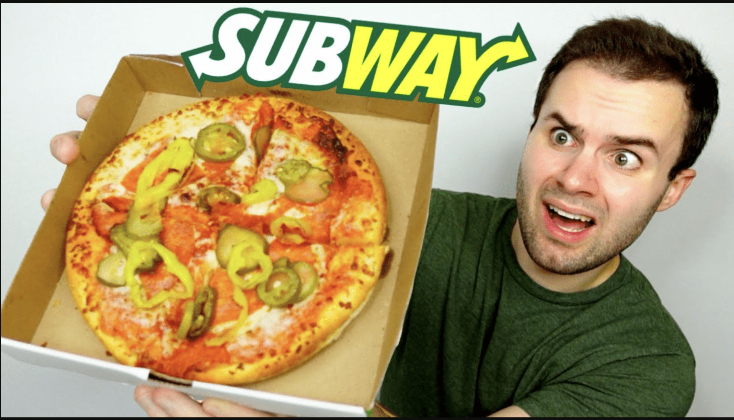 Man holding a. Subway pizze