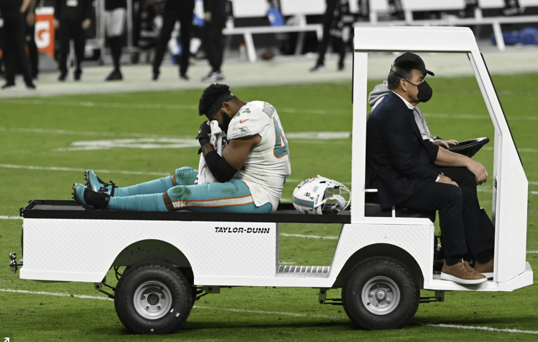 Miami Dolphins outside linebacker Elandon Roberts (44) is driven off the field after an injury against the Las Vegas Raiders during the second half of an NFL football game, Saturday, Dec. 26, 2020, in Las Vegas. Hamstring pulls, ligament tears and ankle sprains can be as formidable an opponent for NFL teams as a high-scoring offense or stingy defense.