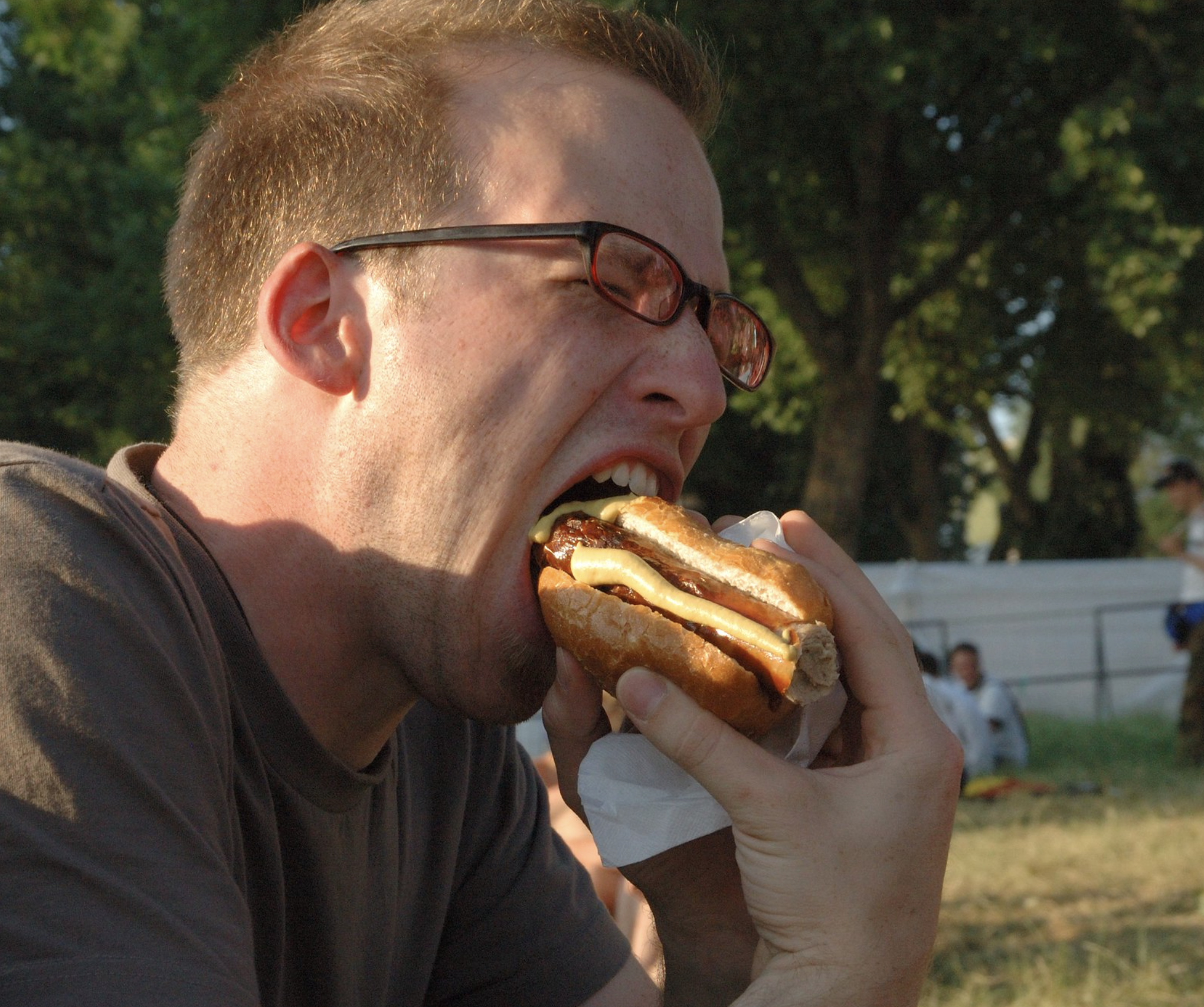 man eating a hot dog