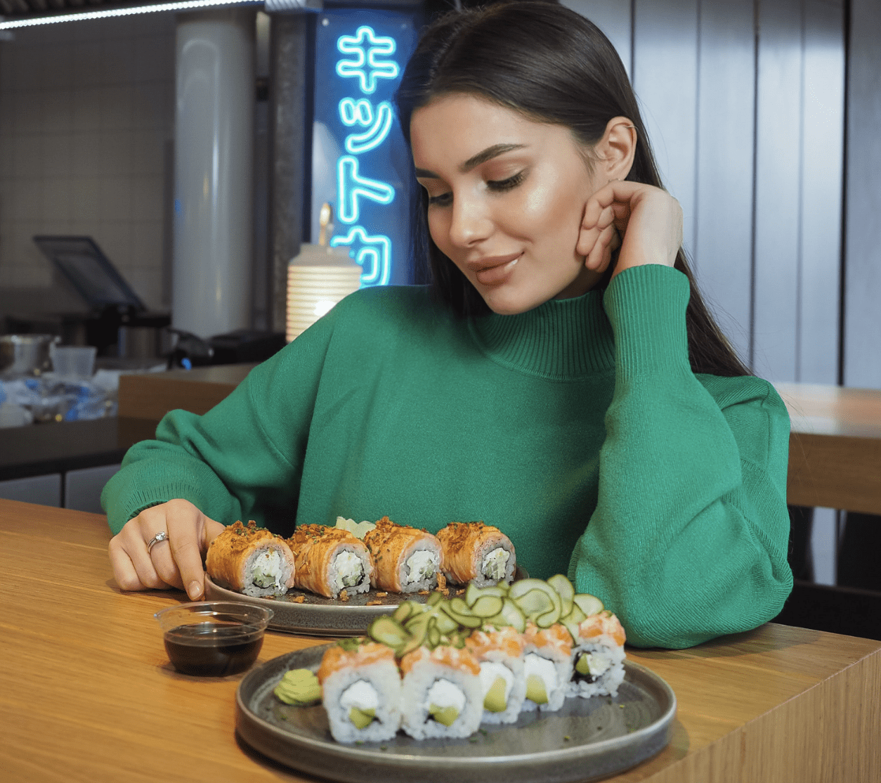 Woman Sitting at the Table with Sushi